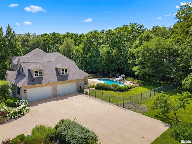 4851 Sheridan Rd, Groveland, IL 61535 - view of side of home featuring driveway, brick siding, roof with shingles, and a forest view