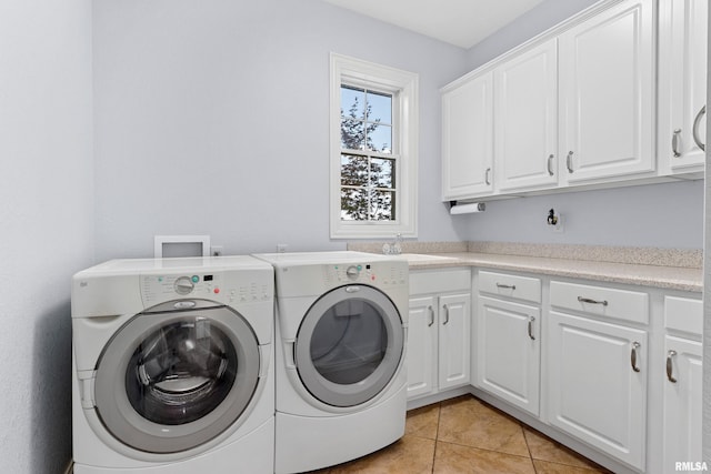 4851 Sheridan Rd, Groveland, IL 61535 - laundry area featuring cabinet space, washing machine and dryer, and light tile patterned flooring