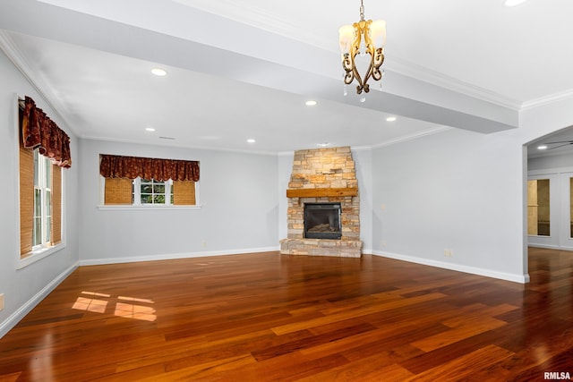 4851 Sheridan Rd, Groveland, IL 61535 - unfurnished living room with a chandelier, crown molding, wood finished floors, a stone fireplace, and recessed lighting