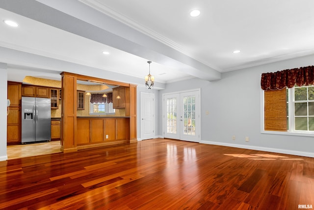 4851 Sheridan Rd, Groveland, IL 61535 - unfurnished living room with wood finished floors, plenty of natural light, recessed lighting, crown molding, and french doors