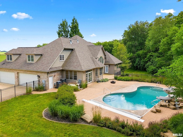 4851 Sheridan Rd, Groveland, IL 61535 - view of pool with a patio, a fenced backyard, and a water slide