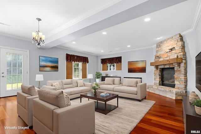 4851 Sheridan Rd, Groveland, IL 61535 - living room with ornamental molding, wood finished floors, a chandelier, recessed lighting, and a stone fireplace