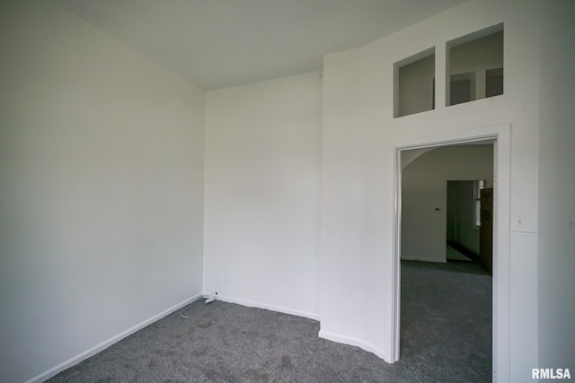 1107 E Frye Ave, Peoria, IL 61603 - spare room featuring dark carpet and baseboards