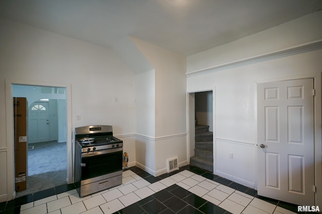 1107 E Frye Ave, Peoria, IL 61603 - kitchen featuring stainless steel gas range oven, tile patterned flooring, and carpet