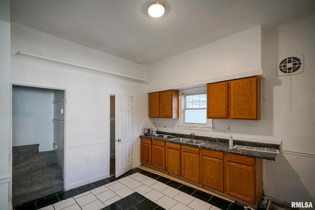 1107 E Frye Ave, Peoria, IL 61603 - kitchen featuring brown cabinets and tile patterned floors