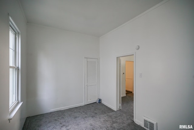 1107 E Frye Ave, Peoria, IL 61603 - unfurnished room featuring dark carpet and plenty of natural light
