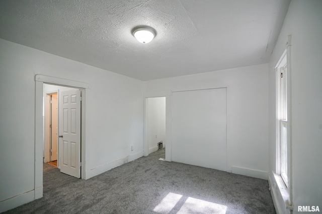 2320 W Krause Ave, Peoria, IL 61605 - unfurnished bedroom with carpet and a textured ceiling