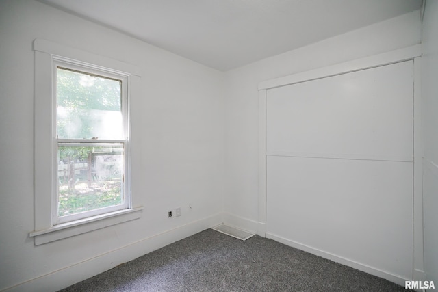 2320 W Krause Ave, Peoria, IL 61605 - spare room featuring dark carpet and baseboards