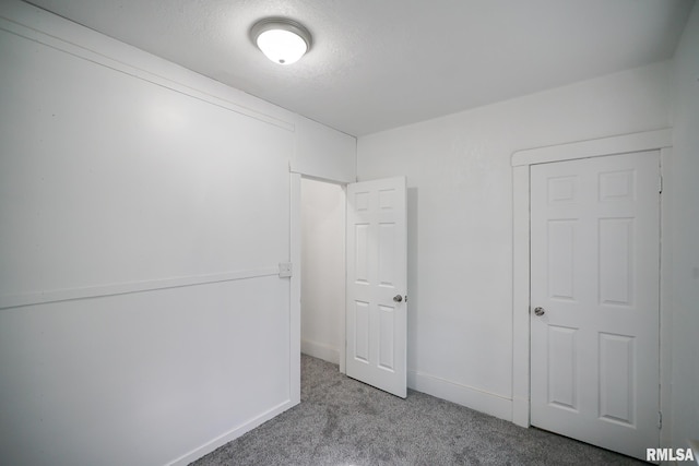 2320 W Krause Ave, Peoria, IL 61605 - unfurnished bedroom with carpet floors and baseboards