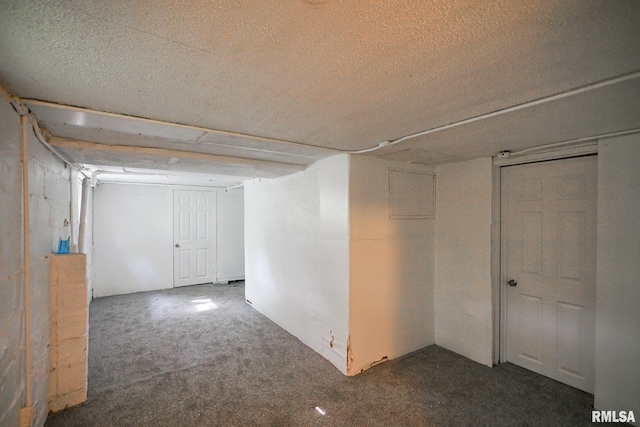 2320 W Krause Ave, Peoria, IL 61605 - below grade area featuring a textured ceiling and carpet