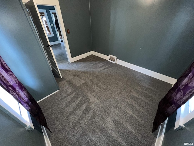 909 W Mcclure Ave, Peoria, IL 61604 - empty room with dark colored carpet and baseboards