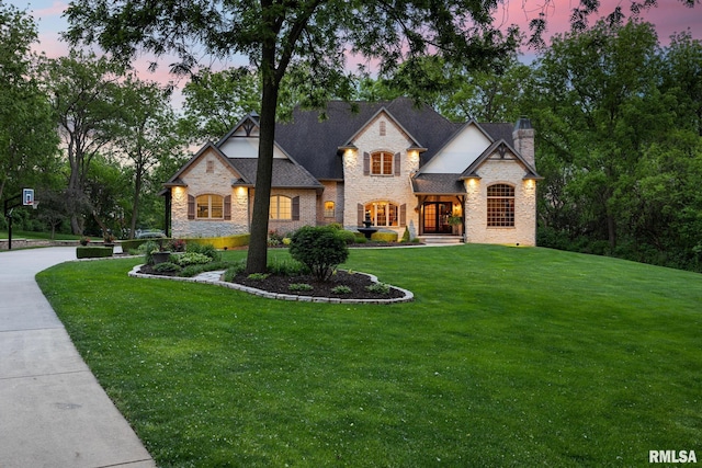 2204 W Pinnacle Dr, Dunlap, IL 61525 - french country inspired facade with stone siding, a front yard, and a chimney