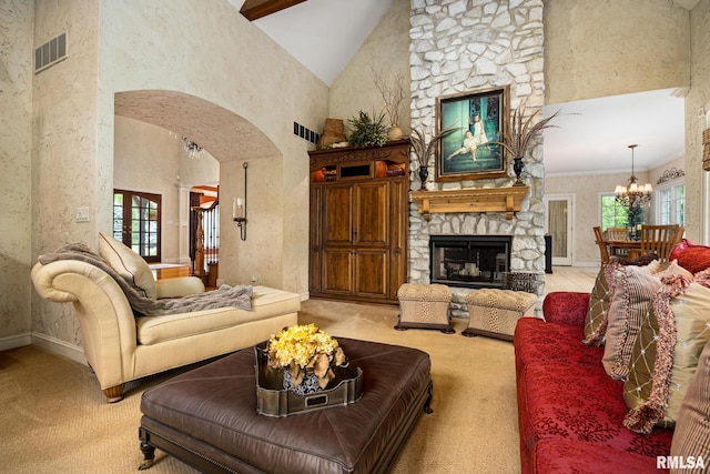 2204 W Pinnacle Dr, Dunlap, IL 61525 - living room with arched walkways, carpet floors, a fireplace, a chandelier, and high vaulted ceiling