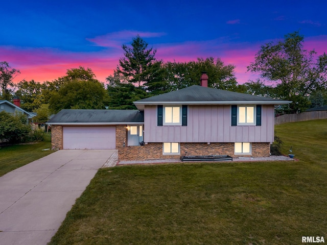 2816 N Kingston Dr, Peoria, IL 61604 - tri-level home featuring an attached garage, a chimney, concrete driveway, and brick siding