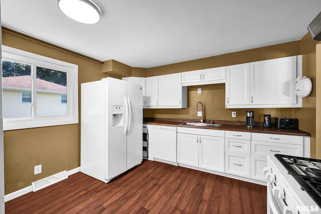 2816 N Kingston Dr, Peoria, IL 61604 - kitchen featuring white appliances, dark countertops, dark wood finished floors, and white cabinetry