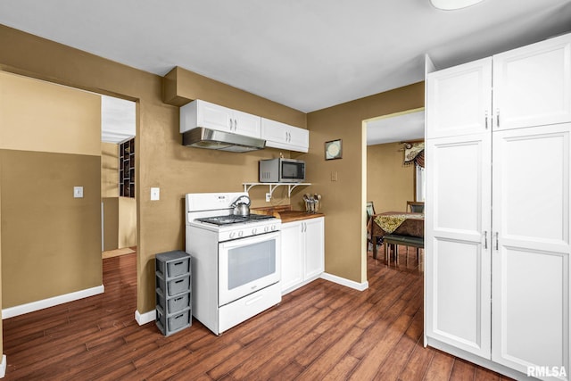 2816 N Kingston Dr, Peoria, IL 61604 - kitchen with white gas range, stainless steel microwave, under cabinet range hood, dark wood finished floors, and white cabinetry