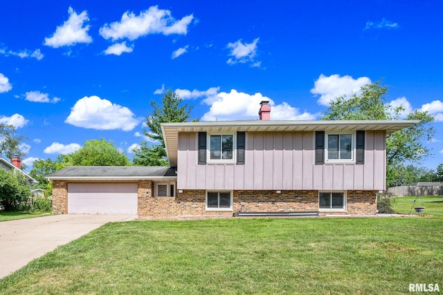2816 N Kingston Dr, Peoria, IL 61604 - tri-level home with a garage, a front lawn, driveway, a chimney, and brick siding