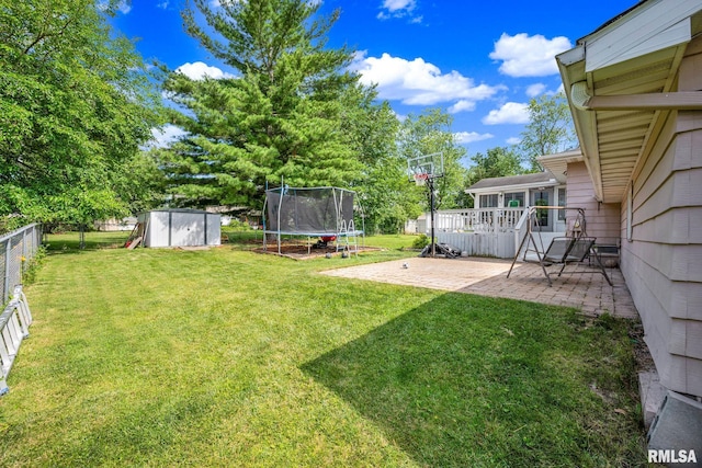 2816 N Kingston Dr, Peoria, IL 61604 - fenced backyard featuring a trampoline, a storage shed, and a patio area