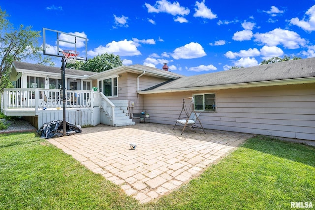 2816 N Kingston Dr, Peoria, IL 61604 - rear view of house with a patio area, a wooden deck, a lawn, and a sunroom