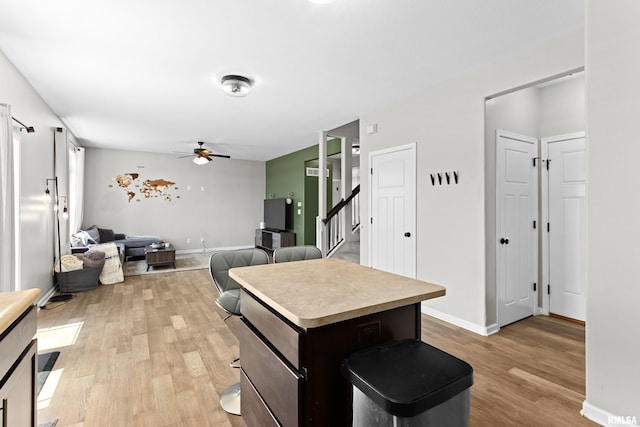 1604 Savile Ln, Washington, IL 61571 - kitchen featuring a ceiling fan, light wood-type flooring, a kitchen island, open floor plan, and light countertops