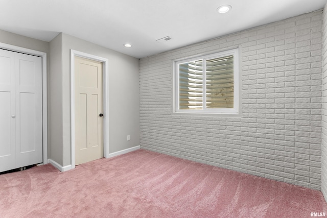 1604 Savile Ln, Washington, IL 61571 - unfurnished bedroom with carpet flooring, recessed lighting, brick wall, and a closet