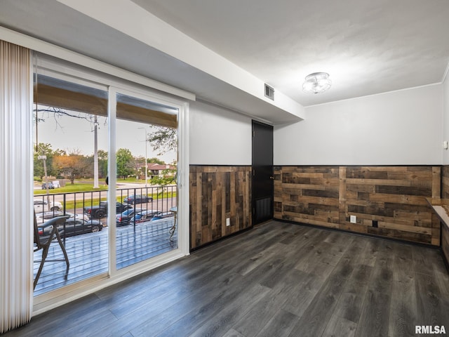 3119 W Willow Knolls Rd Unit 37B, Peoria, IL 61614 - unfurnished room featuring dark wood finished floors, wainscoting, wooden walls, and a chandelier