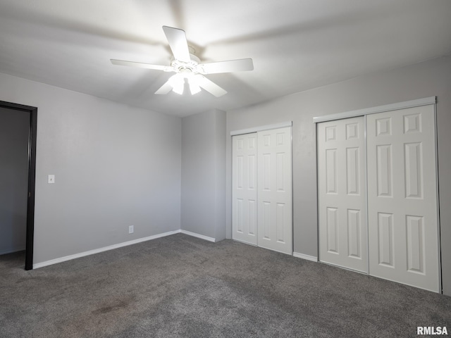 3119 W Willow Knolls Rd Unit 37B, Peoria, IL 61614 - unfurnished bedroom featuring two closets, dark colored carpet, and ceiling fan