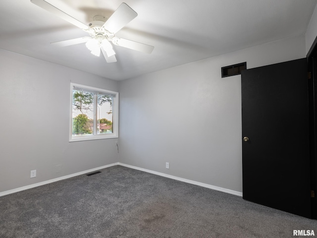 3119 W Willow Knolls Rd Unit 37B, Peoria, IL 61614 - spare room with dark carpet and a ceiling fan