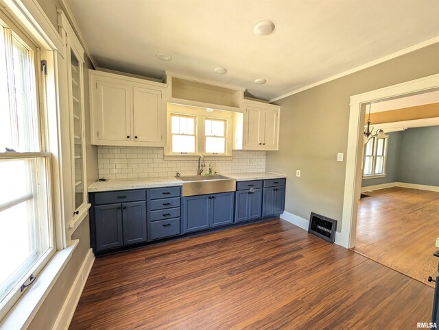 1101 S 4th St, Pekin, IL 61554 - kitchen with decorative backsplash, a chandelier, dark wood-type flooring, crown molding, and white cabinetry