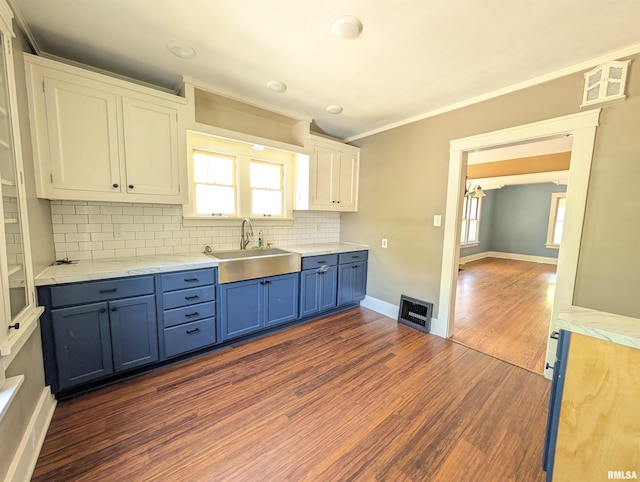 1101 S 4th St, Pekin, IL 61554 - kitchen featuring blue cabinetry, dark wood-style flooring, backsplash, crown molding, and white cabinetry