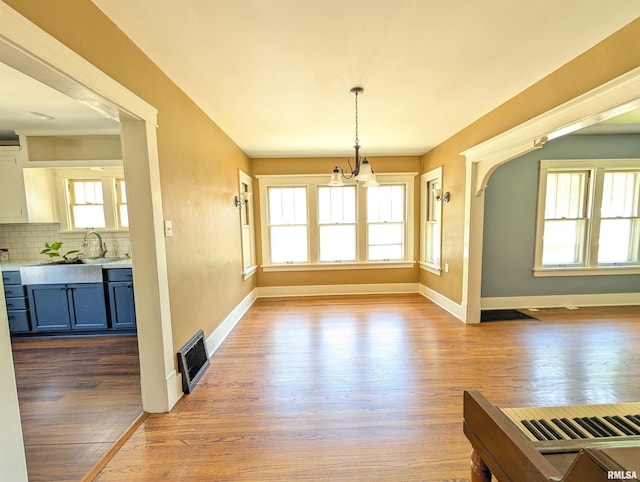 1101 S 4th St, Pekin, IL 61554 - unfurnished dining area with wood finished floors and a chandelier