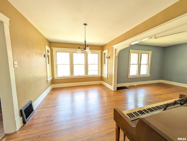 1101 S 4th St, Pekin, IL 61554 - unfurnished dining area with wood finished floors and a chandelier