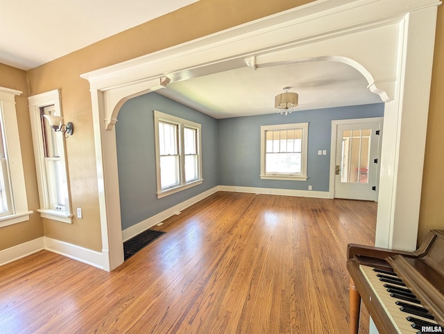 1101 S 4th St, Pekin, IL 61554 - empty room featuring arched walkways and wood finished floors