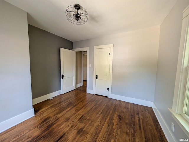 1101 S 4th St, Pekin, IL 61554 - spare room with baseboards and dark wood-style flooring