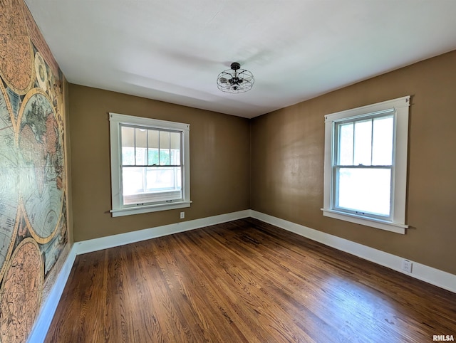 1101 S 4th St, Pekin, IL 61554 - spare room featuring dark wood finished floors and a chandelier