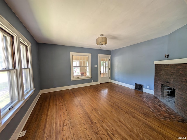 1101 S 4th St, Pekin, IL 61554 - unfurnished living room with a fireplace and wood finished floors