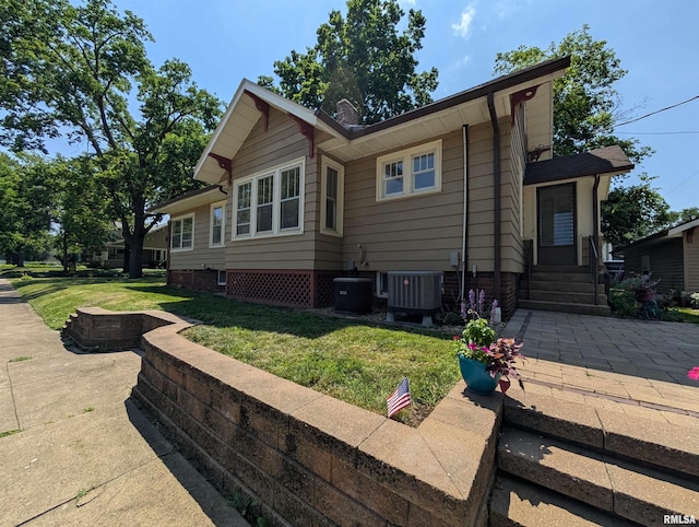 1101 S 4th St, Pekin, IL 61554 - view of side of home with a lawn, a patio area, and entry steps