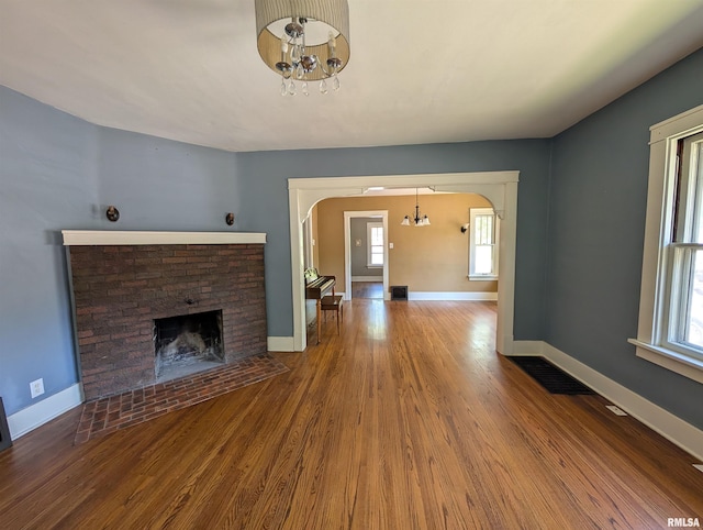 1101 S 4th St, Pekin, IL 61554 - unfurnished living room with arched walkways, a chandelier, and healthy amount of natural light