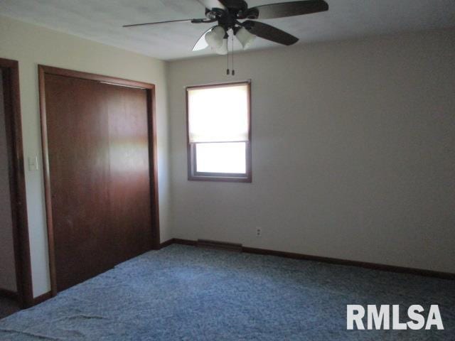 1265 Spring Bay Rd, East Peoria, IL 61611 - unfurnished bedroom featuring carpet floors and a ceiling fan