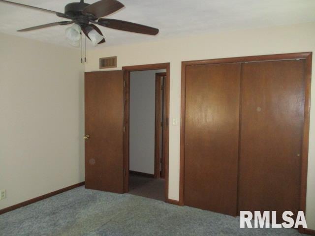 1265 Spring Bay Rd, East Peoria, IL 61611 - unfurnished bedroom featuring carpet floors, a closet, and a ceiling fan