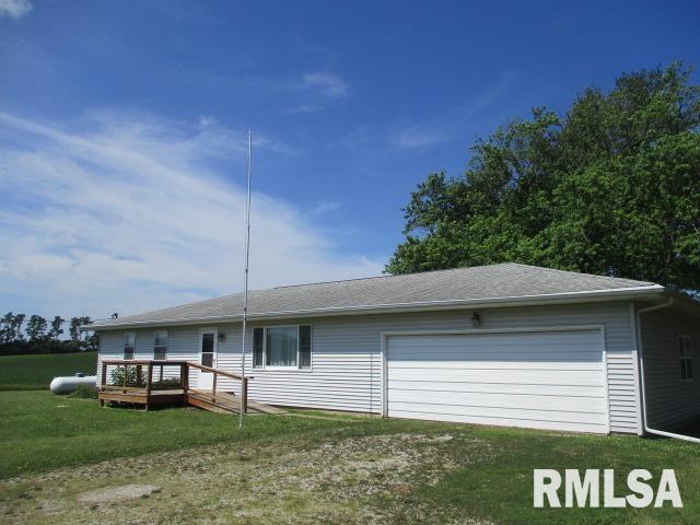 1265 Spring Bay Rd, East Peoria, IL 61611 - view of front facade with a front yard, a wooden deck, and an attached garage