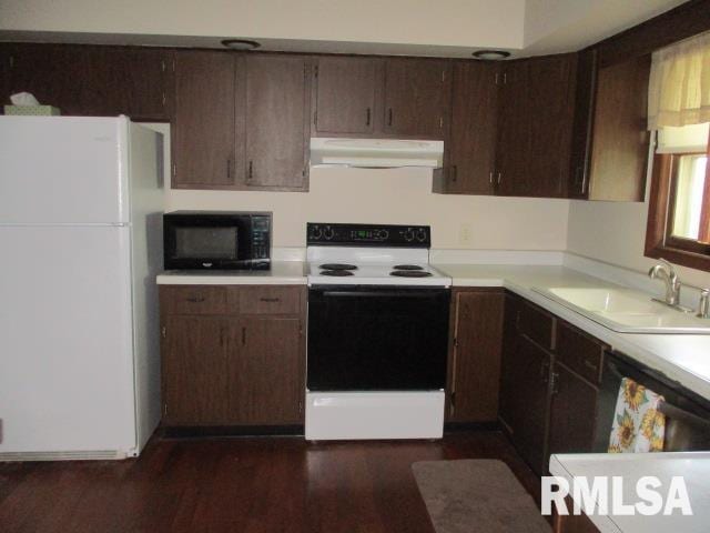 1265 Spring Bay Rd, East Peoria, IL 61611 - kitchen featuring white appliances, under cabinet range hood, light countertops, and dark wood-style floors