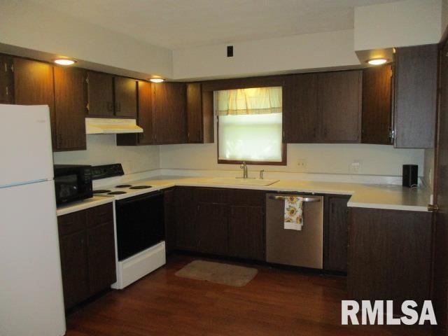 1265 Spring Bay Rd, East Peoria, IL 61611 - kitchen featuring white appliances, under cabinet range hood, light countertops, dark wood finished floors, and dark brown cabinets