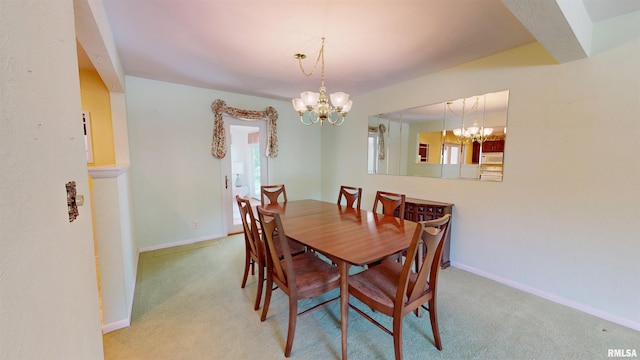1729 W Willow Wood Dr, Peoria, IL 61614 - carpeted dining room with a chandelier and baseboards