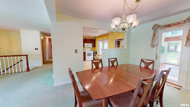 1729 W Willow Wood Dr, Peoria, IL 61614 - dining room with light colored carpet and a chandelier
