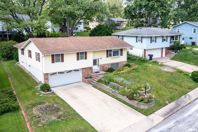1729 W Willow Wood Dr, Peoria, IL 61614 - view of front of house with an attached garage, driveway, and brick siding