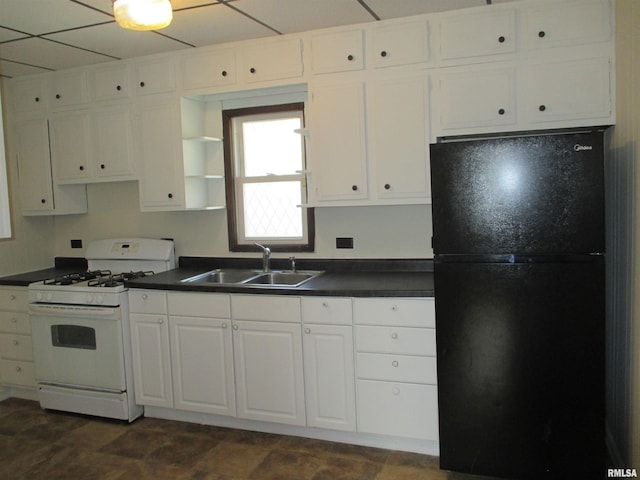 1810 W Latrobe St, Peoria, IL 61605 - kitchen with freestanding refrigerator, white gas range, dark countertops, and white cabinetry