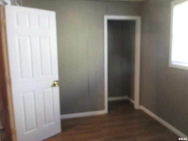 1810 W Latrobe St, Peoria, IL 61605 - unfurnished bedroom featuring baseboards and dark wood-style flooring