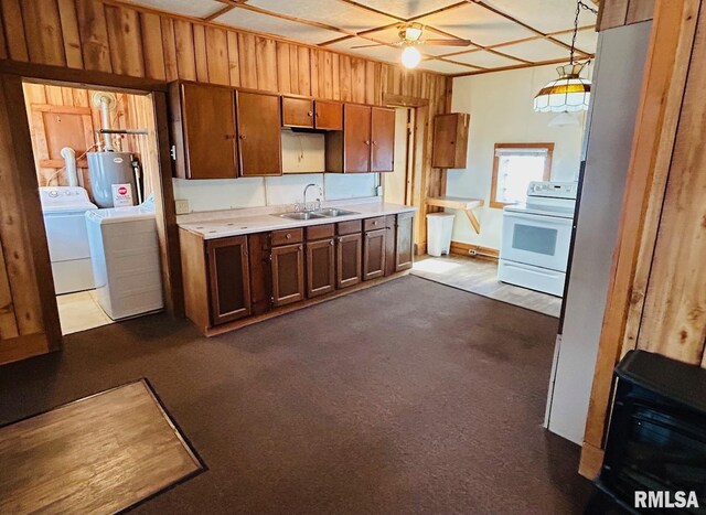 1305 S 8th St, Pekin, IL 61554 - kitchen featuring white electric range, washer and clothes dryer, light countertops, water heater, and dark colored carpet