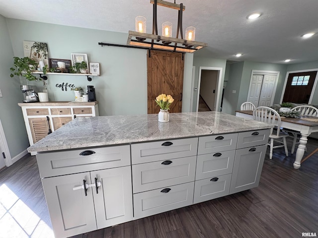 276 E Far Hills Dr, East Peoria, IL 61611 - kitchen with light stone counters, recessed lighting, dark wood-style flooring, decorative light fixtures, and a textured ceiling